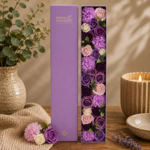 Lavender Rose & Carnation Soap Flower Gift Box featuring elegant lavender, purple, blush pink and ivory floral soap blooms beautifully presented in a luxury display box on a rustic wooden table with soft linen, ceramic accessories and warm natural light, creating a calming slow living gift scene.