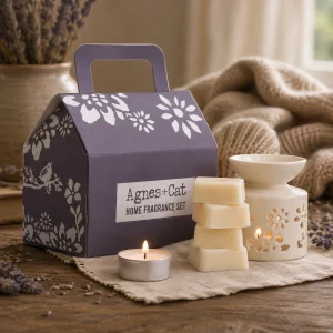 Windermere Home Fragrance Gift Set displayed on a rustic wooden table with a ceramic wax melt burner, scented wax melts, a glowing tealight, dried lavender and soft linen in a calming slow living setting.