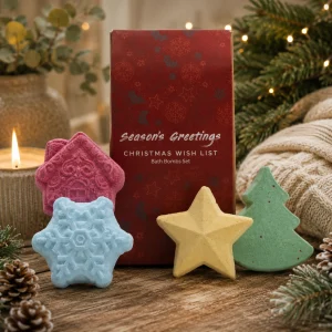 Christmas Wish List Bath Bomb Gift Set displayed in a cosy festive setting with handcrafted Christmas tree, star, snowflake and gingerbread house bath bombs.