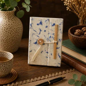 Handmade mini Lokta paper notebook with natural cream paper and delicate blue cotton fibres, twine closure and wooden button