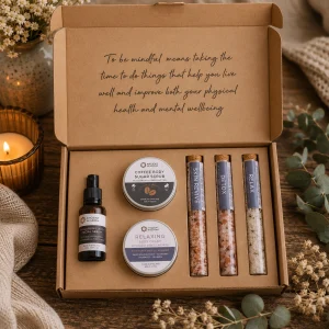 Mindful Moments Self-Care Kit displayed open in a kraft gift box, containing coffee sugar body scrub, relaxing body cream, hyaluronic acid serum and three bath salt vials labelled Skin Revive, Detox and Relax.